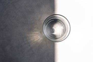 Close-up of a glass of clean water on a concrete table....