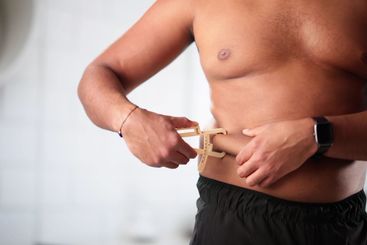 Fitness Trainer Measures Body Fat on Client