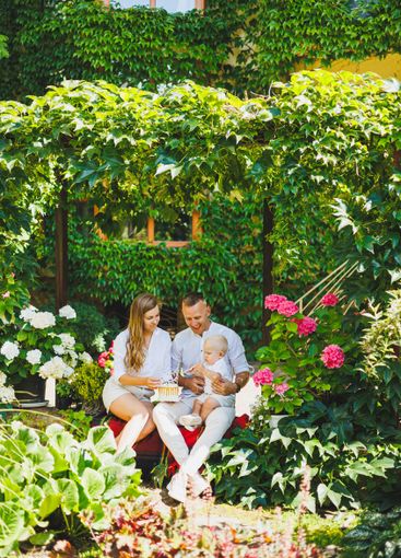 Mom and dad in nature with their one-year-old son...