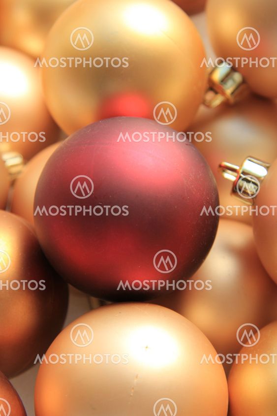 Red ornament on a pile of golden ornaments