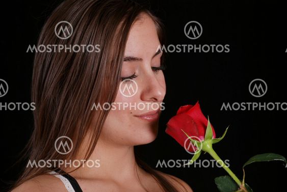 Woman smelling a red rose