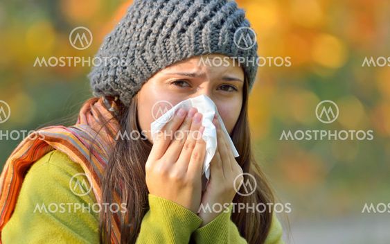 girl with allergy or cold using tissue