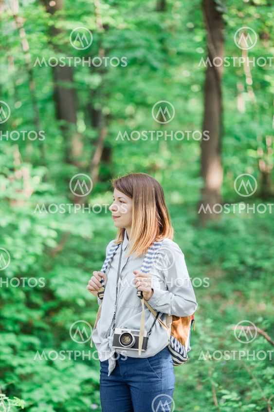 Young female photographer in the forest