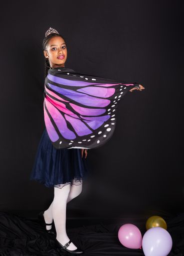 Brunette teen girl wearing butterfly wings confident and...