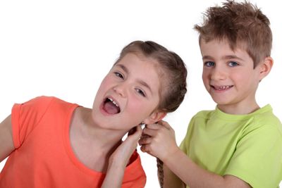 Boy pulling girl's hair