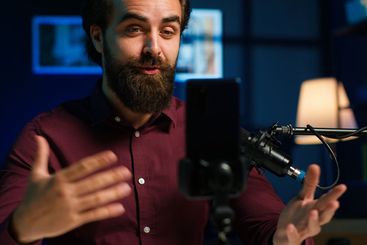 ASMR content creator using quality mic and cellphone on...