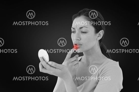 Composite image of worried woman looking at her lips