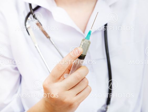 nurse holds syringe