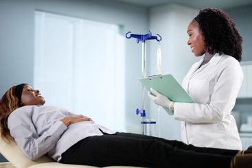 Female African American Patient Receives Vitamin...