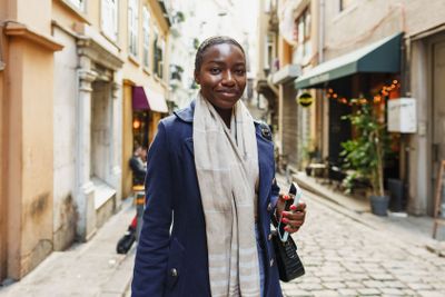 Young african woman walks alone on europe street