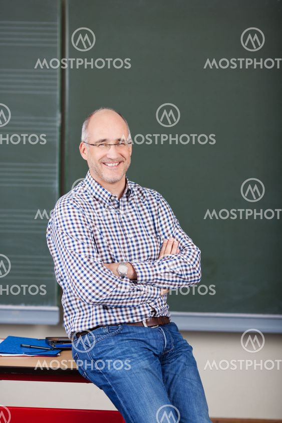 Professor With Arms Crossed Sitting On Desk