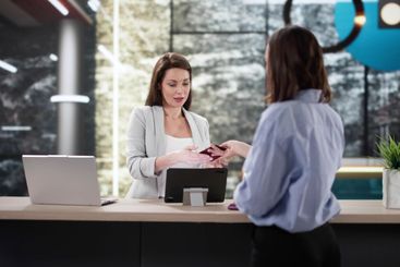 Traveling Woman Checking into Hotel, Talking to...