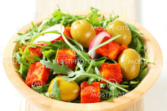 Salad greens with olives and spicy cheese
