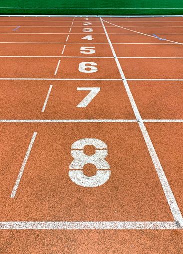 Running tracks and finish line in outdoor sport stadium