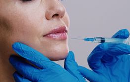 Hands, injection and lip filler in studio with closeup...