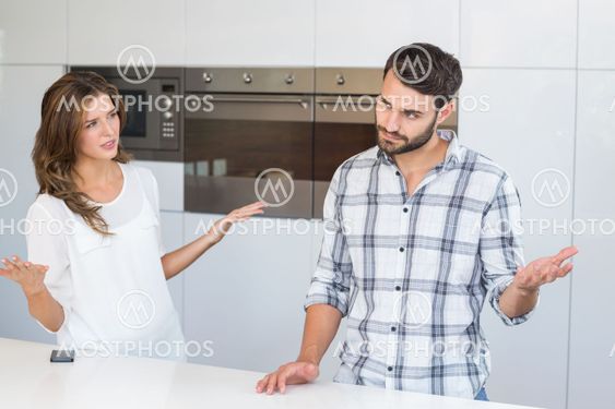 Woman explaining man by table