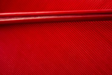 Close-Up of a Vibrant Red Feather Showing Intricate...