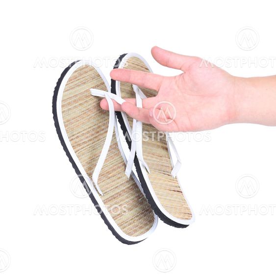 Pair of striped flip-flop sandals in hand.