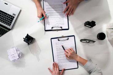 Female Lawyer Reviewing Documents And Negotiating Contracts