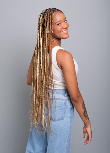 Beautiful brunette woman with braids in her hair wearing...