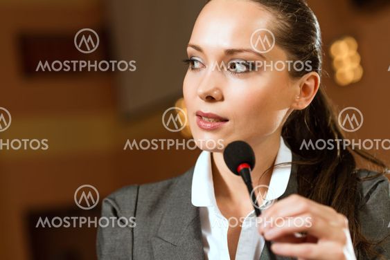 Portrait of a business woman with microphone