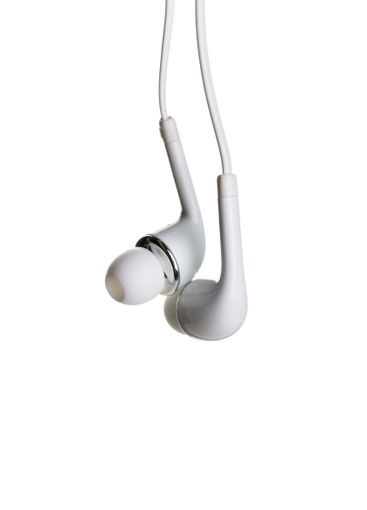 Pair of earphones close up on grey background