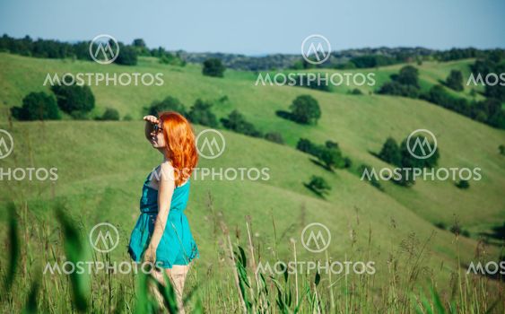 Young woman enjoying a view of the hill