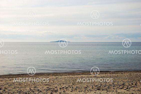 View at an island from a sandy beach