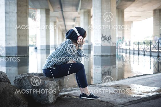 beautiful young blonde hipster woman listening music