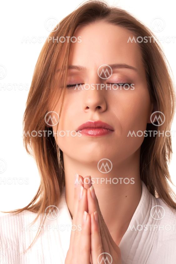 Young woman sitting with pray gesture and eyes closed