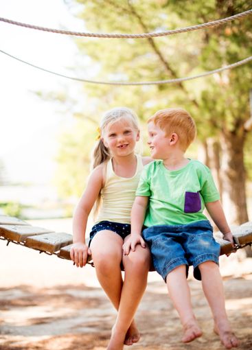 Fun, portrait and children hugging in park for bonding,...