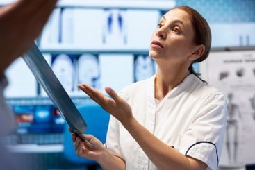 Doctors and nurses analyze human anatomy scans results...