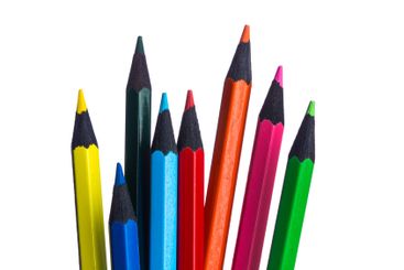 Colorful assortment of sharpened pencils arranged on a...
