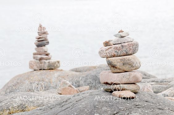 Two piles of stones on the rock, the sea in the background