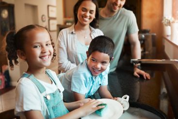 Kitchen, children and washing dishes with parents, happy...