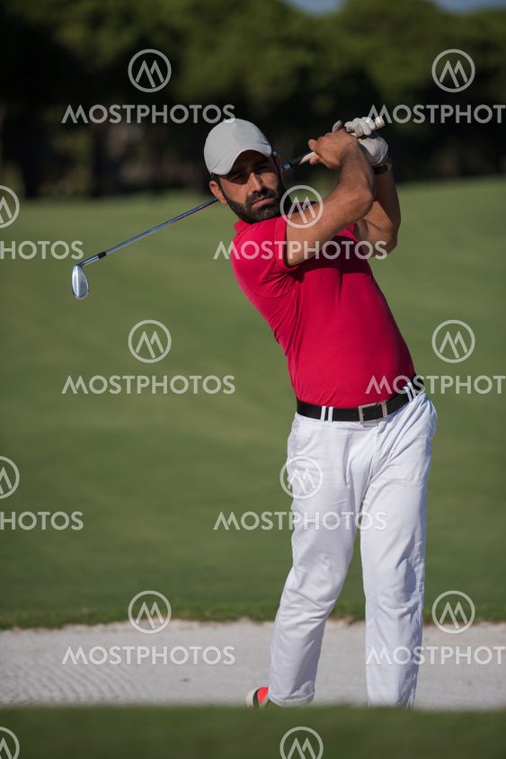 golfer hitting a sand bunker shot
