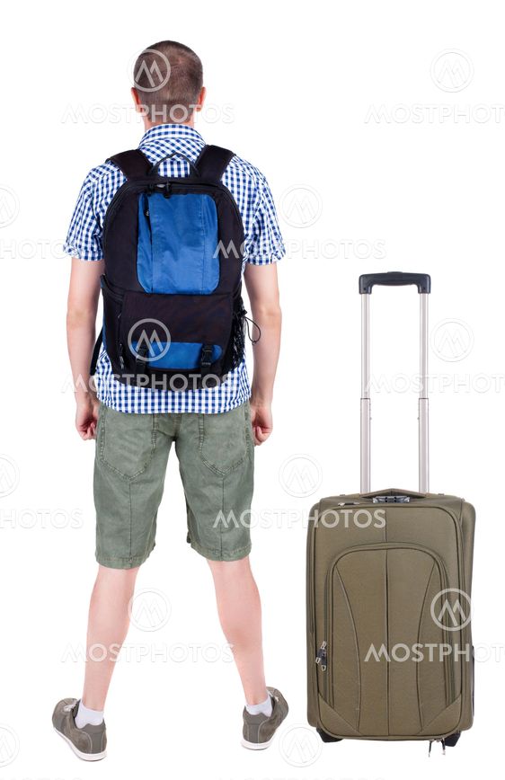 Back view of young man traveling with suitcas.
