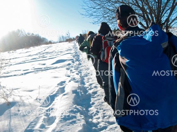 Team of tourists going for track. Winter Caucas