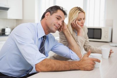 Business couple not talking after an argument in kitchen