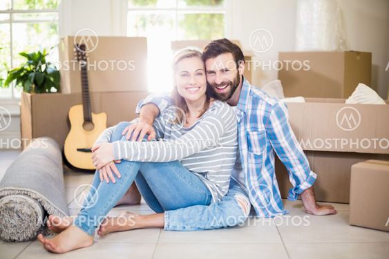 Portrait of smiling couple sitting on floor