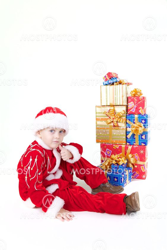 Boy in christmas clothes with presents