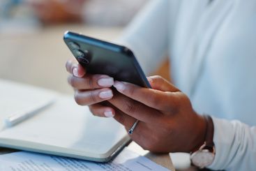 Research, notebook and hands of person with phone and...
