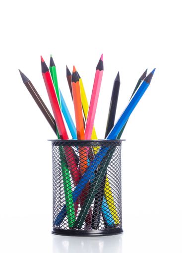Colorful pencils arranged in a black mesh holder on a...