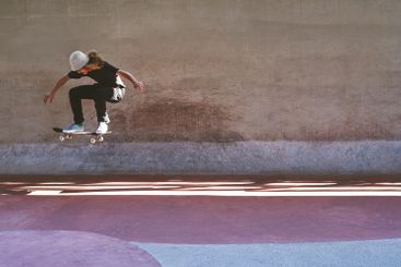 Culture, skateboard and jump with man at park for urban,...