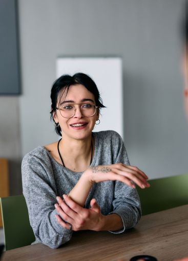 A close up portrait of a young businesswoman engaged in...