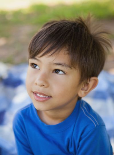 Boy looking away in thought at park