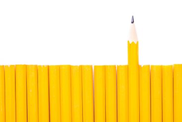 Unique arrangement of yellow pencils with one sharpened...