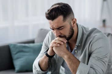 Unhappy depressed caucasian handsome bearded man crying...