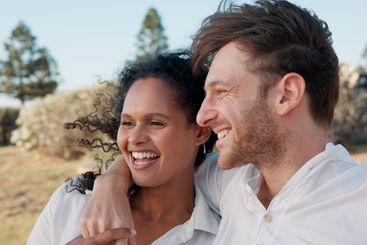 Love, interracial couple and laughing together outdoor...