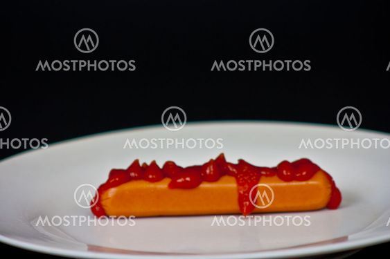 Hot dog with Ketchup on top.